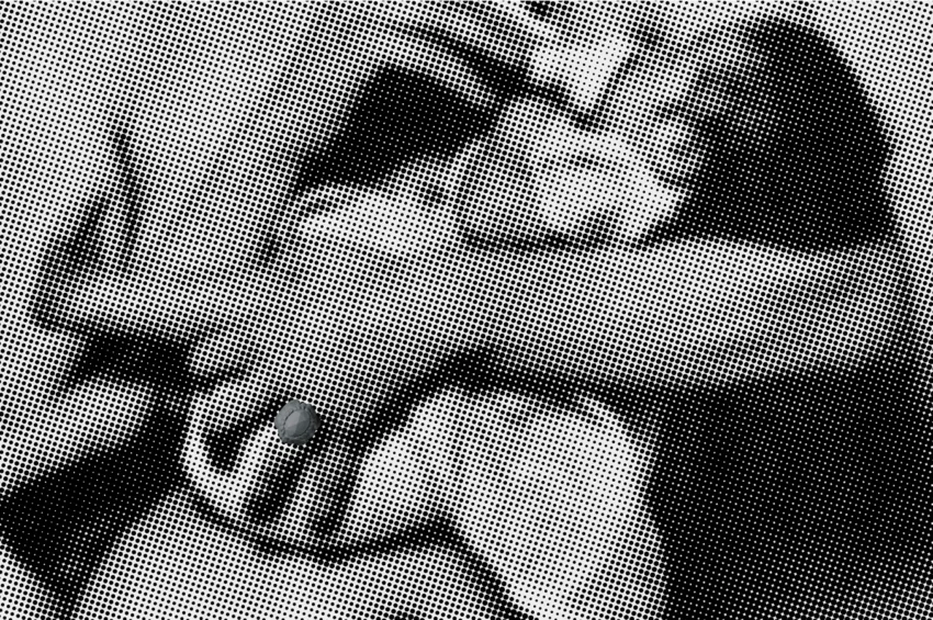 A strong woman's arm holding a baby, a ring on her finger.